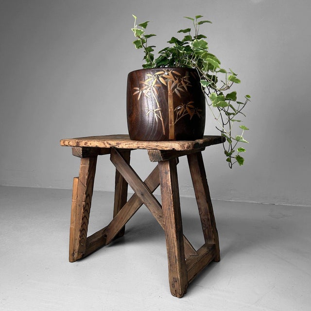 Discover the timeless charm of this decorative wooden stool from the 1920s. with its beautiful, weathered patina and...