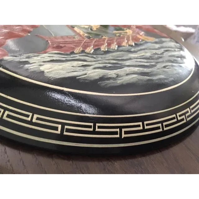 This is a very interesting piece of decorative art. Made of pottery with a raised design of a Greek mythology image. It is...