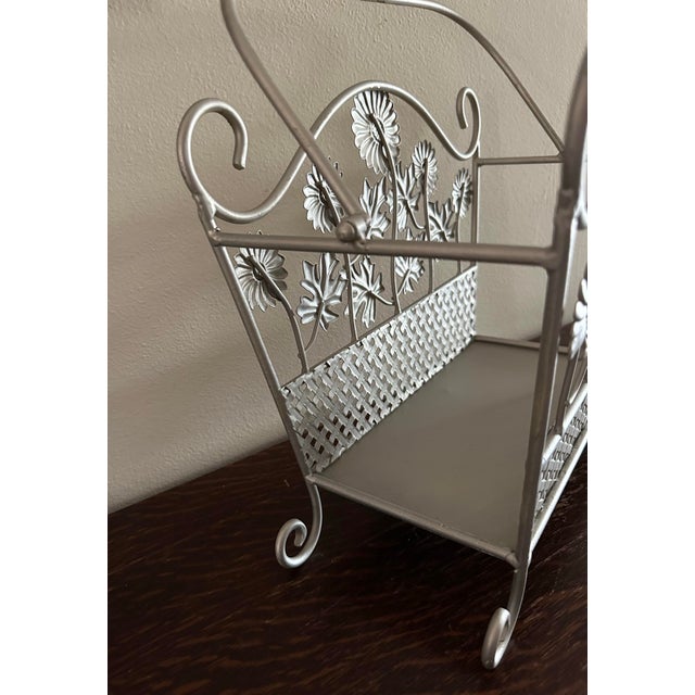 Pretty vintage iron basket with floral design. Silver in color with moveable handle. Great basket that can serve many...