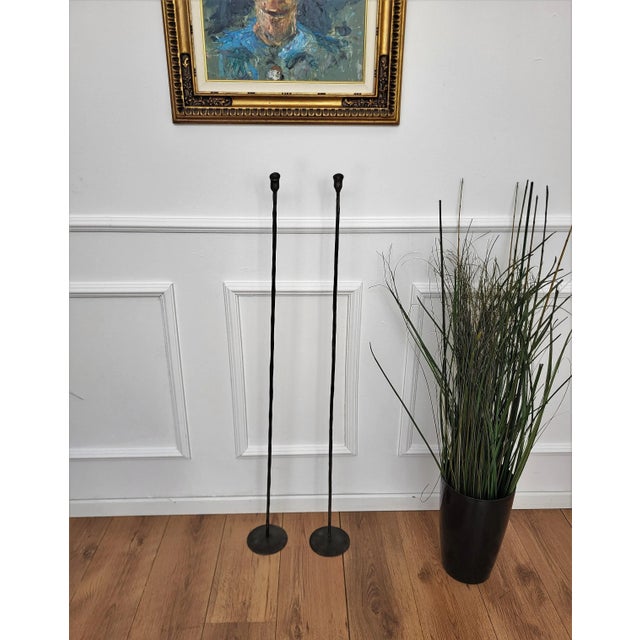 Pair of wrought iron tall floor candle holders in brutalist Giacometti style.