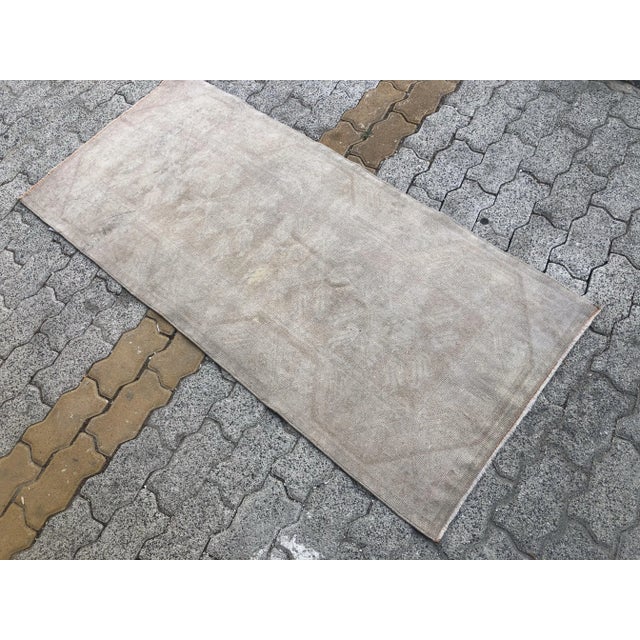 This is a vintage Turkish Oushak rug from the 1960s. The piece was hand-knotted.