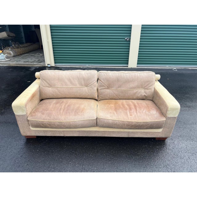 Stylish sofa crafted circa 1990s in the Contemporary / Postmodern style, featuring soft two-tone leather upholstery in...