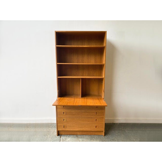 A Mid-century modern Danish teak wall unit designed and manufactured by Sejling Skabe in the 1960s. This modular mid-...