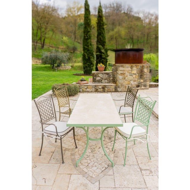 Betel is an outdoor dining table with a travertine top and metal frame, made in Italy and designed for convivial outdoor...