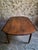 An antique French oak drop leaf dining table dating from around 1850–1880. Made from solid oak, the table has a round top...