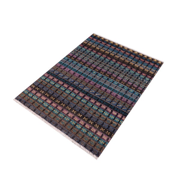 Elevate your interior with this hand-knotted high-low wool area rug, designed to bring depth and dimension to any room....