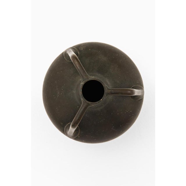 This bronze vase, produced in Sweden during the 1940s by an unknown designer, exemplifies a classical form rendered...