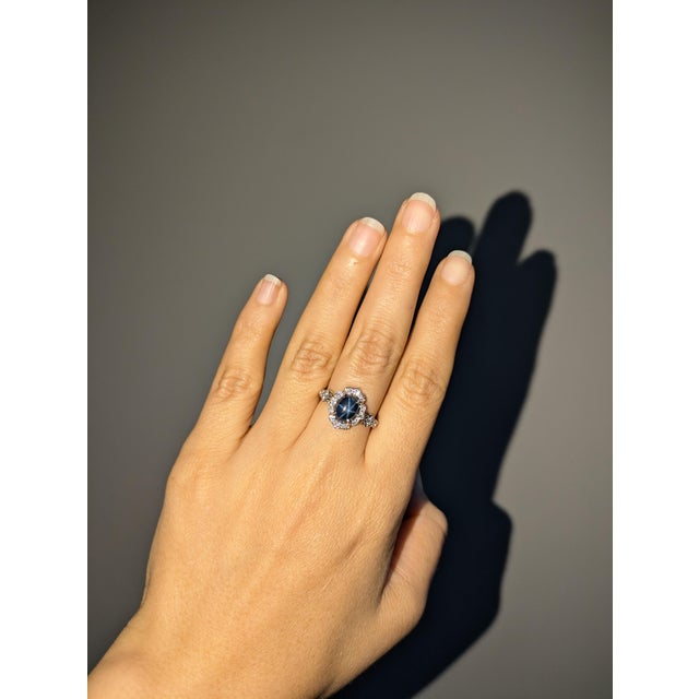 This elegant 14k gold ring (3.45g) features a captivating 3.55-carat oval star sapphire from Ceylon (9x7mm), showcasing a...