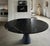 Origin: Italy Overall Dimensions: 72" Diameter x 30"Height (1 1/4" thick tabletop) Materials: Nero Marquina, base carved...