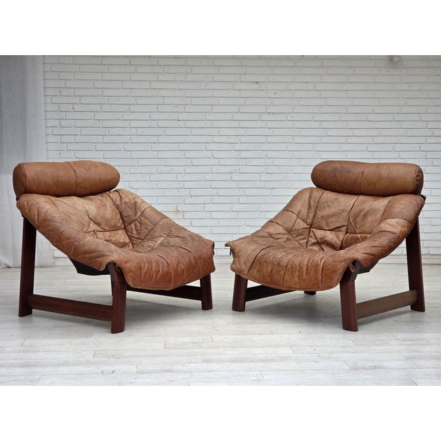 1970s, Norwegian design by Jan Erik Lindgren. Armchair model "Amazon". Original light brown furniture leather, teak wood,...