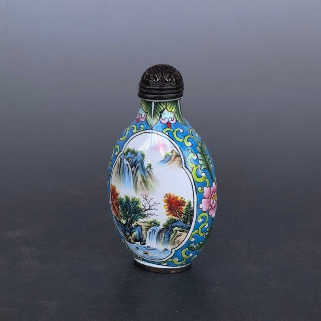 This exquisite vintage Chinese snuff bottle is crafted from copper with vibrant painted enamel work. The bottle is...