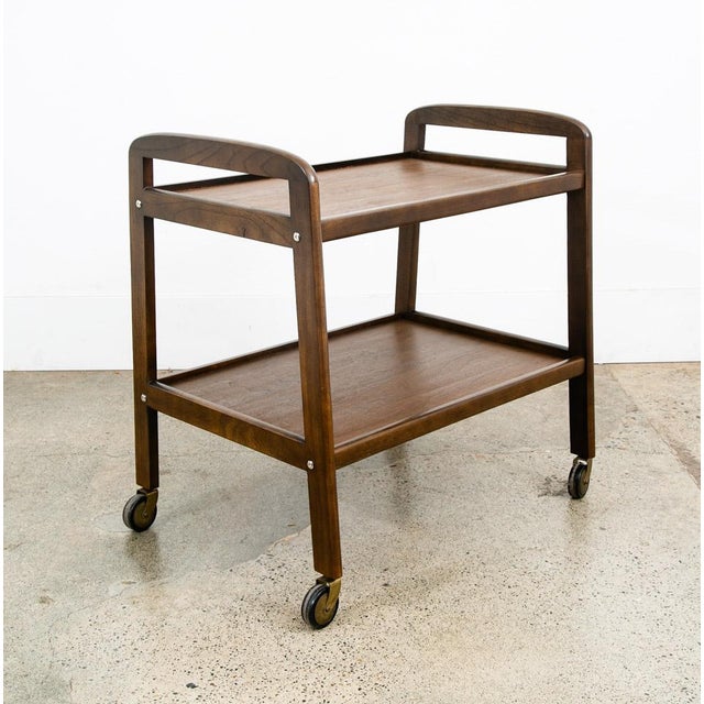 High quality walnut bar cart by unknown American maker. Very fine details and construction. The piece sits casters and...