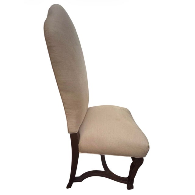 A handsome set of six vintage dining chairs in black walnut comprised of four side chairs and two armchairs. These...