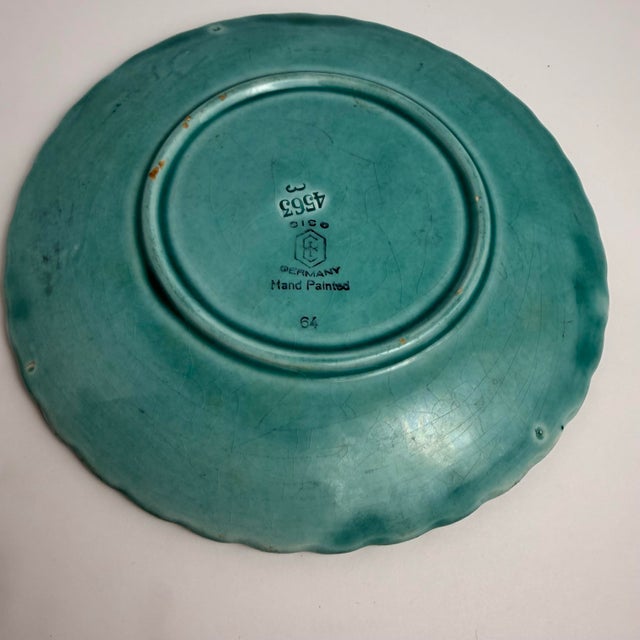 A beautifully hand‑painted German majolica plate by CICO, featuring a raised basketweave pattern and a delicate...