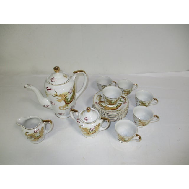 A porcelain hand-painted white and gold Sunray Kutani dragon ware Japanese 15 pc tea service. The set consist of 6 cups, 6...