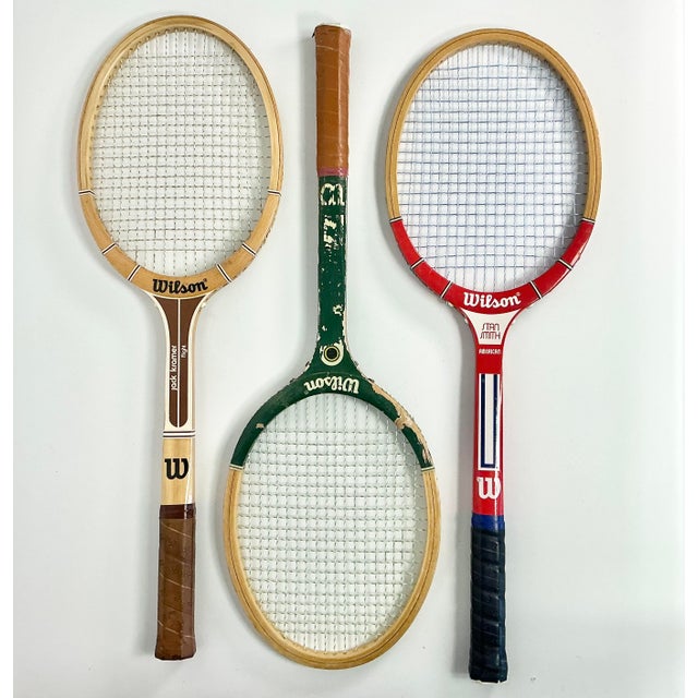 This is a set of Vintage Wilson Wood Tennis Rackets from the 1950-1970s. The green racket is the oldest and has chippy...