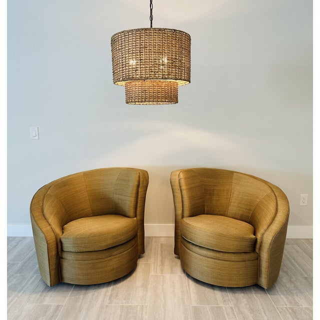 Elevate your living space with this sophisticated pair of contemporary barrel swivel chairs, where sculptural form meets...