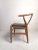This impressive mid-century style chair is modeled after Hans Wegner's famous "Wishbone" design. Featuring a sturdy oak...