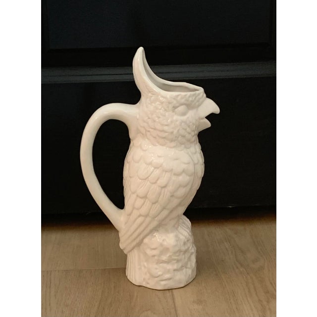 Whimsical tall ceramic jug featuring a molded cockatoo.