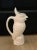 Whimsical tall ceramic jug featuring a molded cockatoo.