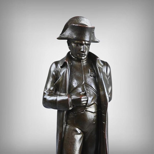 This bronze reveals Napoleon in all his grandeur, frozen in a pose that has become mythical, his hand tucked into his...