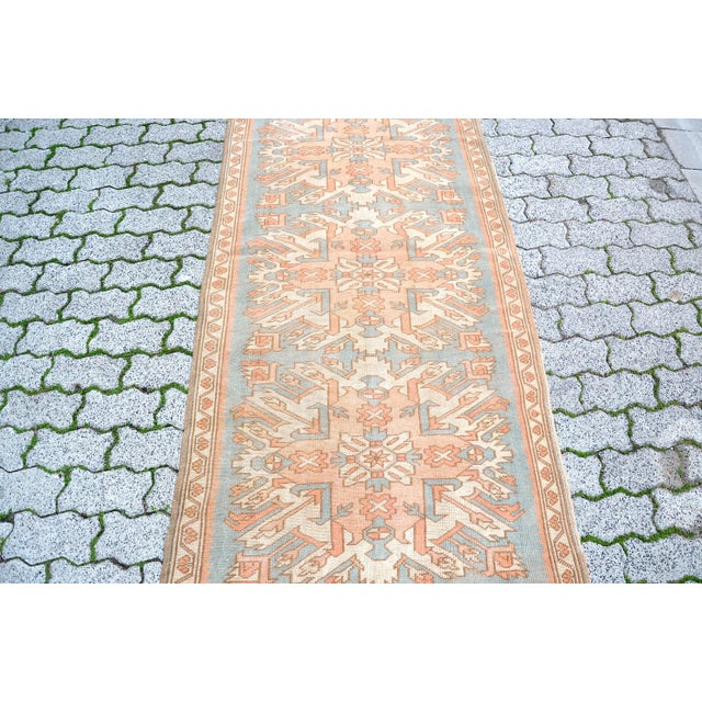 This is a vintage Turkish Oushak rug from the 1960s. The piece was hand-knotted.