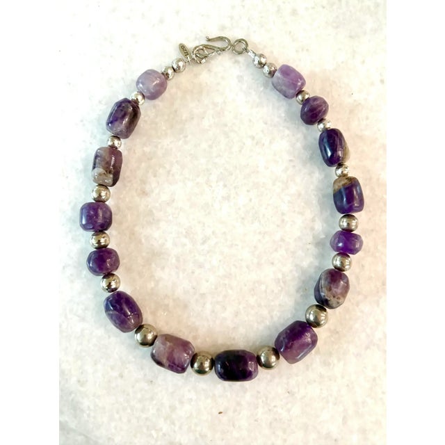 Rare, antique hand carved pre-Columbian amethyst beads. Handmade with silver spacers and clasp. Restrung by Matthew Izzo.