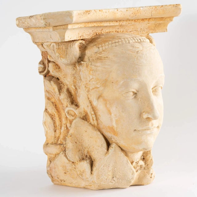 Unique vintage wall shelf crafted from plaster in a light tan hue with textured finish. Features sculpted goddess face and...