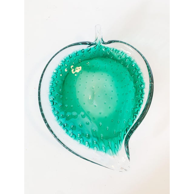 A vibrant and lovely vintage Murano hand blown glass leaf catch all dish in teal. The design has beautiful bubbles...