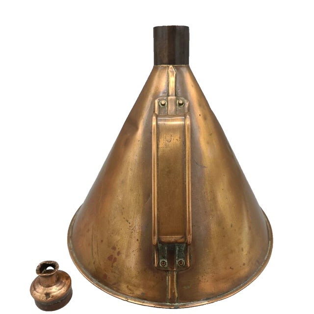 A charming Prohibition-era handcrafted copper moonshine still, complete with its original fitted lid designed to hold...
