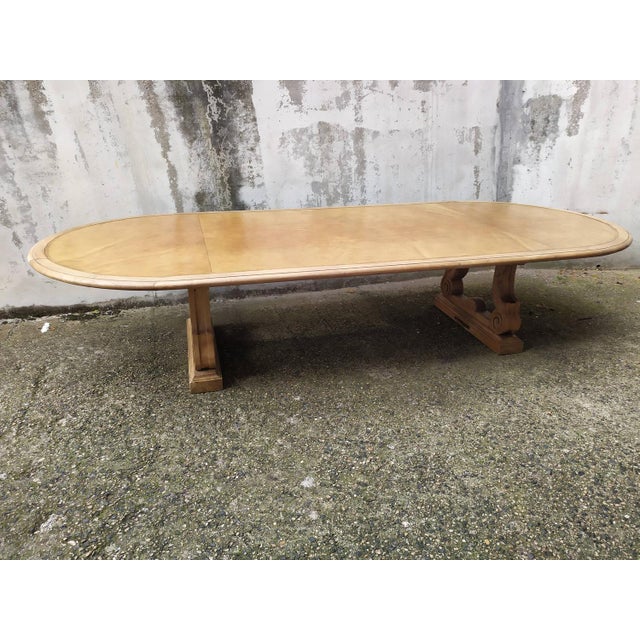 Spanish Renaissance style conference table, stripped solid oak base, leather-covered top. The central crosspiece is...