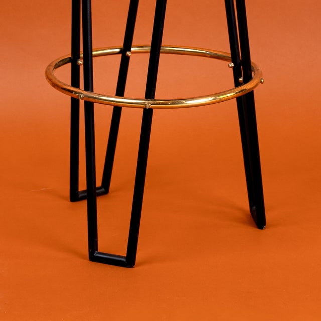 Pair of Italian Mid-Century Modern style bar stools from the 1950s. Each stool features a sleek black lacquered iron frame...