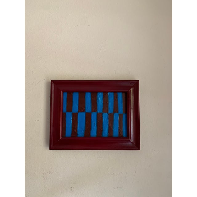 A striking 5x7 acrylic on canvas featuring off-set stripes in deep wine and vibrant blue. The textured brushwork and...