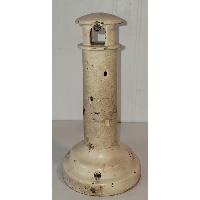 This original cream painted light house bank is stamp " Light of The World " on the front face of the bank.This is a...