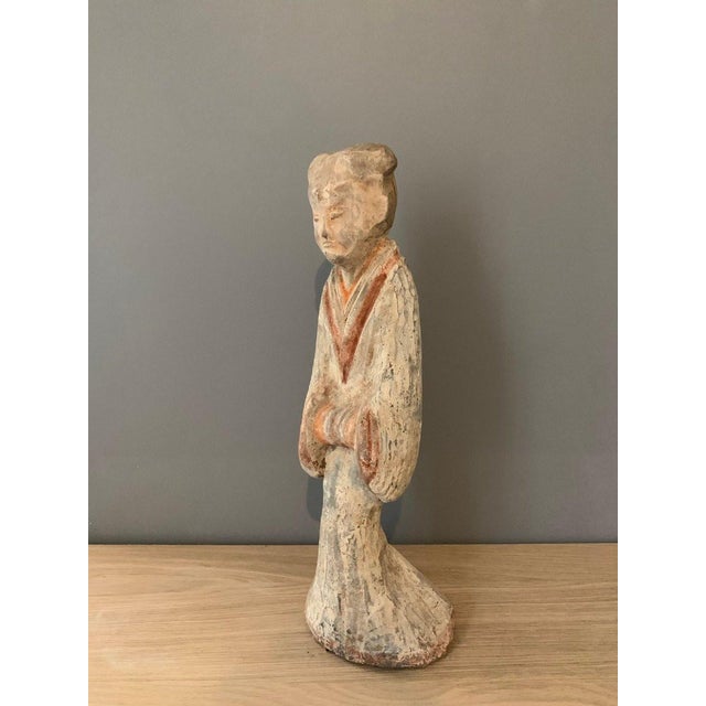 Terracotta sculpture of a court lady, Han Dynasty (206 BC-220 AD). Polychrome painted terracotta. Depicts a lady in an...