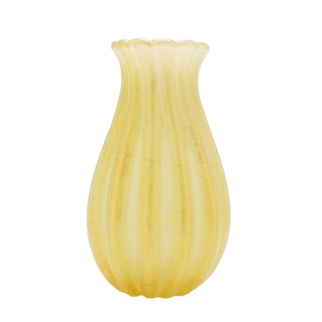 A mid-20th century Murano vase attributed to Archimede Seguso, its pear-shaped body infused with gold leaf and worked in...