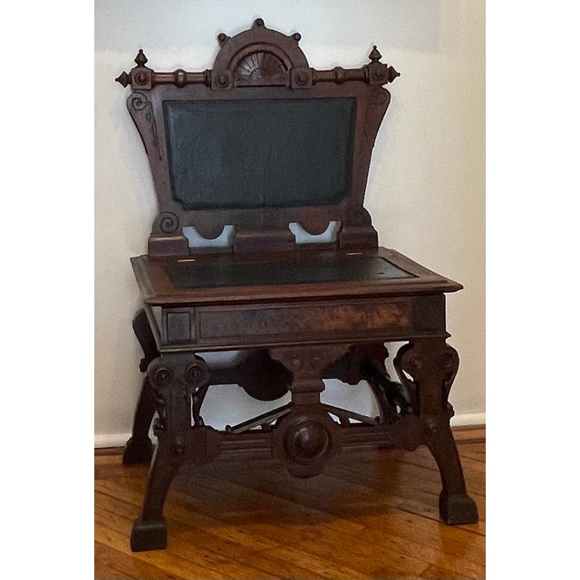Commanding Victorian Bishop’s chair in black leather and Mahogany. Intricate carving with dial-motif, flowers, and bolts....