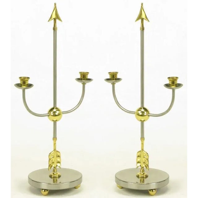 Pair of Italian empire style candelabra with center arrows and u shaped candle holders all intersecting a brass ball....