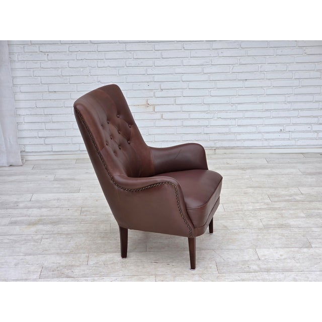 1970s, Danish armchair. Original brown furniture leather, beech wood legs, springs in the seat. Original good condition:...