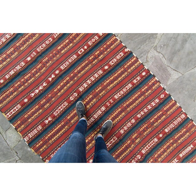 An antique Uzbek flatweave with both soumak and kilim weaving, with stripes and abstract designs, featuring colors such as...