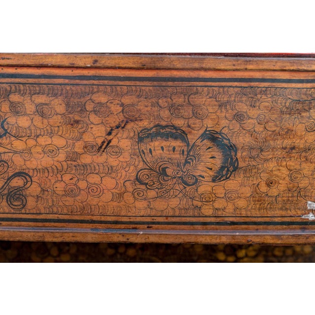An antique Chinese stacked lacquered wedding basket with a red-lacquered wood and bass handle, three tiers of food...