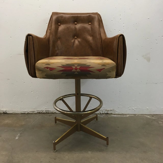 Danish-modern bar stool intricately upholstered, with tufted naugahyde, luxurious padding on the seat, height adjustable...