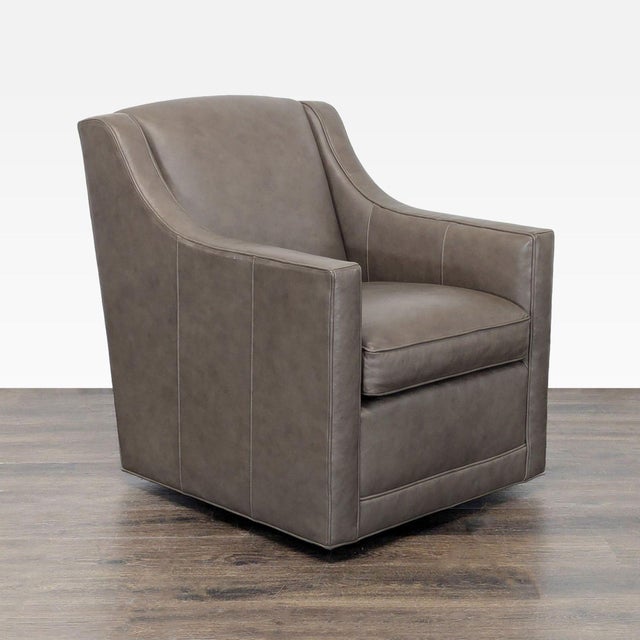 This Lexington lounge chair features a modern design with smooth taupe leather upholstery. The chair offers a comfortable...
