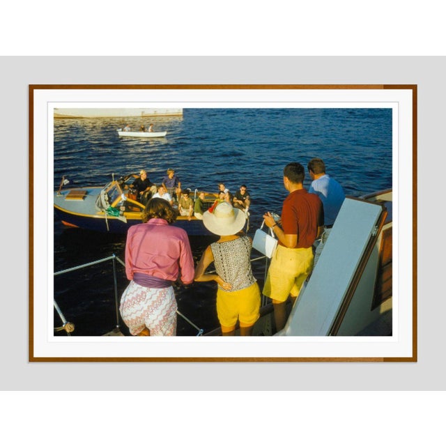 Colourful Sailing by Toni Frissell Brightly dressed family and friends enjoy sailing the coast of Newport, circa 1960....