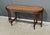 This walnut piano bench, in the refined Louis XVI style, embodies the timeless elegance of period furniture. Its oblong...