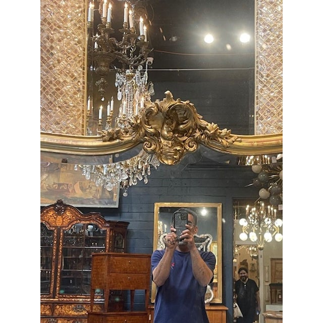 This large 19th c. French Louis XV giltwood shaped mirror is a stunning piece that exudes elegance and sophistication. The...