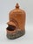 A unique, antique ceramic bird feeder or waterer, shaped like a stylized bird. The object is functional yet features an...