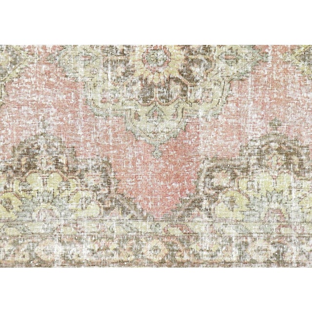 A vintage Turkish Oushak measuring 4'8" x 12'9", hand-woven with wool on wool foundation. This piece displays the region's...