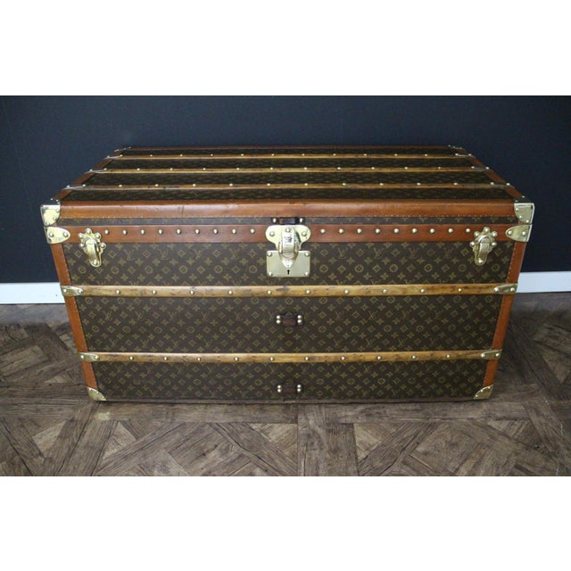 This superb Louis Vuitton trunk features a hand-stenciled monogram canvas, a honey-colored lozine trim, a solid brass...