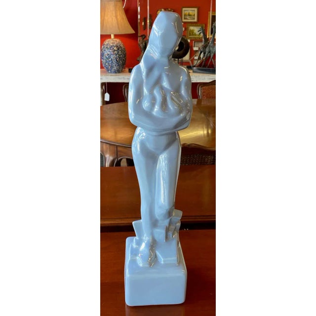Cubist style ceramic statuette of a woman holding an infant by JARU. The nude figure, modeled contra posta, cradles the...